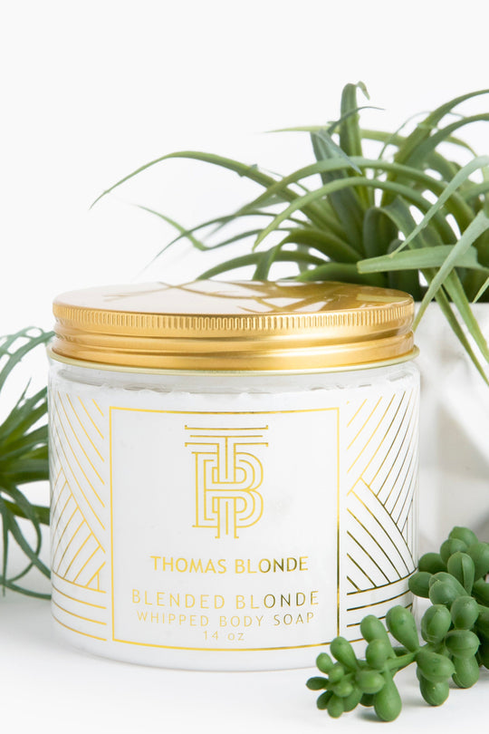 Whipped body soap in a clear jar with blended blonde color.
