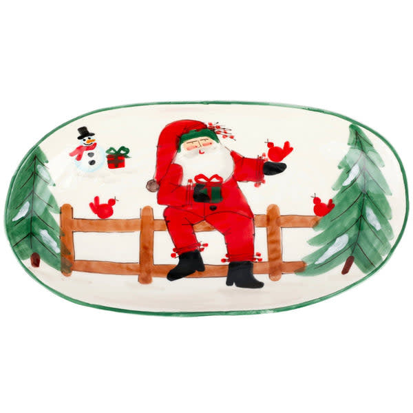 White Terra Bianca earthenware oval bowl featuring whimsical Old St. Nick Santa Claus scenes.