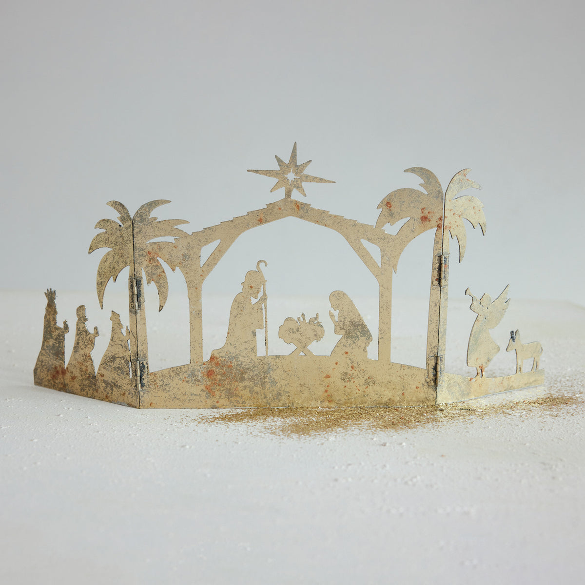 Metal folding mantle nativity scene with a distressed gold finish and silhouette cutouts.