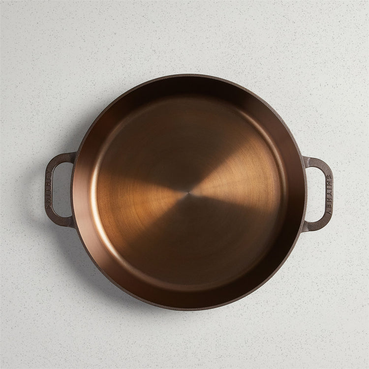 Top-down view of a No. 14 Dual Handle Skillet with a polished copper-colored interior.