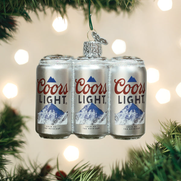 Coors Light six pack glass Christmas ornament hanging on a tree with festive lights.