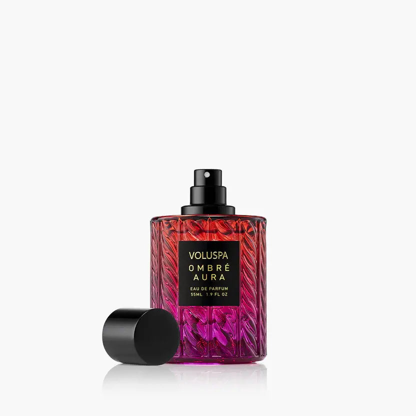 Ombre Aura perfume bottle with a warm amber liquid visible through clear glass.