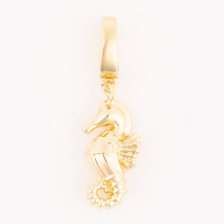 Gold seahorse charm with a polished finish and detailed texture on the body and tail.