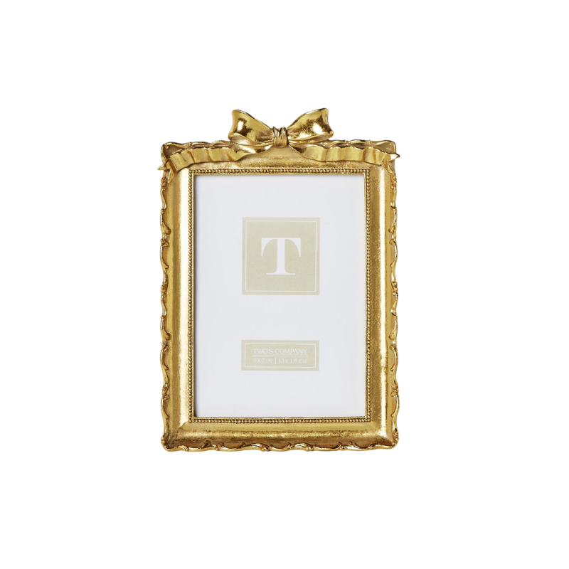 Vintage gold resin picture frame with an ornate scalloped edge and a decorative bow on top.