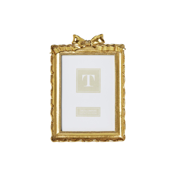 Vintage gold resin picture frame with an ornate scalloped edge and a decorative bow on top.