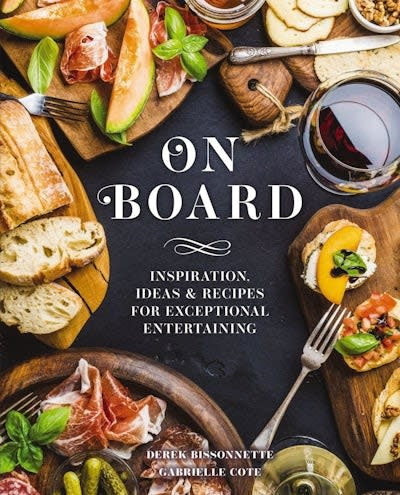 On Board cookbook cover featuring a dark background with artfully arranged food on wooden boards.