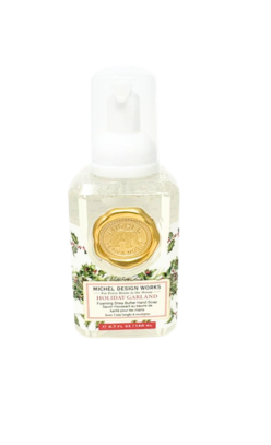 Michel Design Works Holiday Garland mini foaming hand soap with a gold seal and holly design.