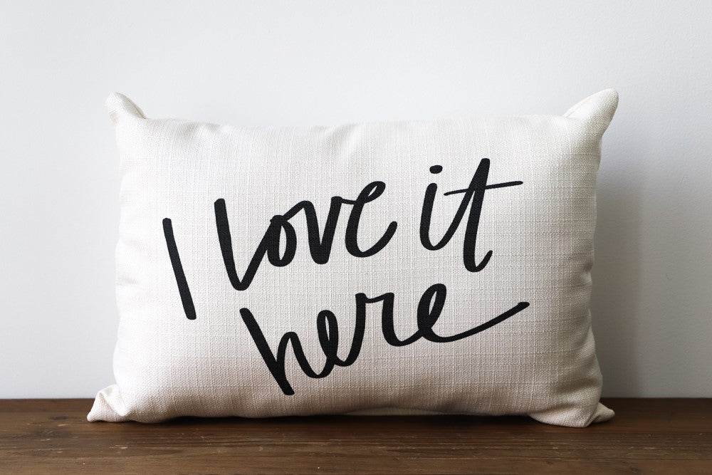 I Love It Here decorative pillow with a soft fabric cover in neutral tones.