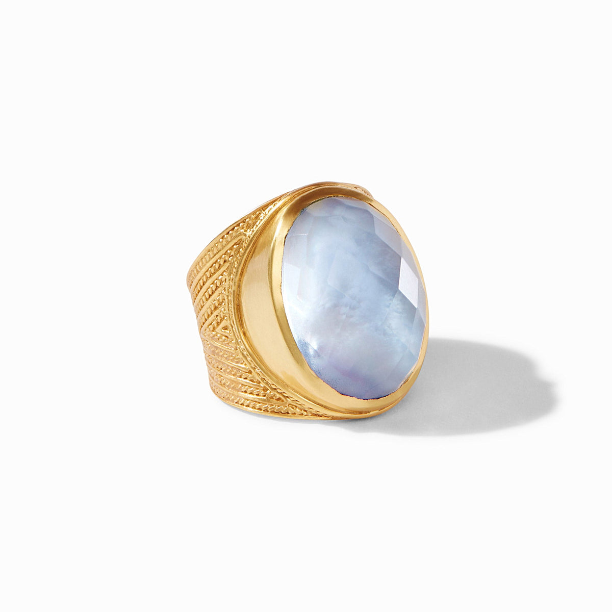 Verona Statement Ring with a faceted blue glass gemstone and gold chevron-detailed band.