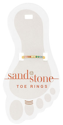 Sand & Stone gold-tone toe ring with a row of multi-colored rainbow crystals on a foot-shaped card.