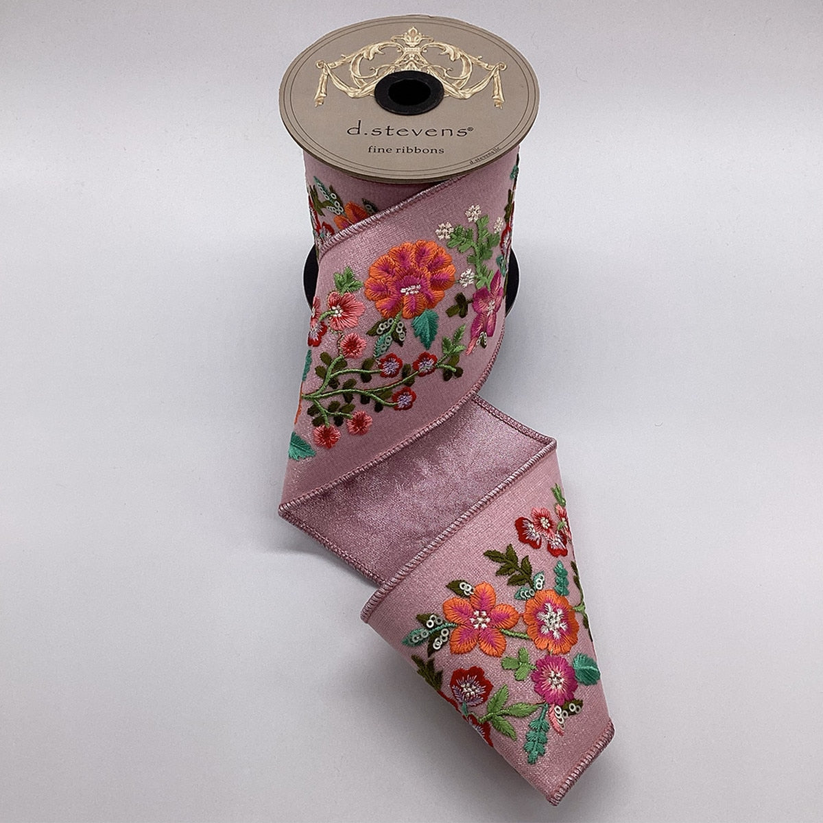 Pink metallic dupion ribbon with orange embroidered flowers and a pink bow.
