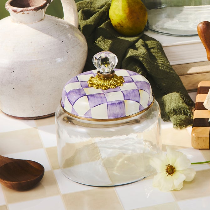 Violet checkered small kitchen canister with a cylindrical shape.