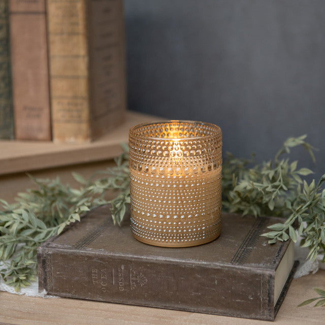 4-inch champagne glass candle with dotted texture featuring a 3D flame silhouette in wax