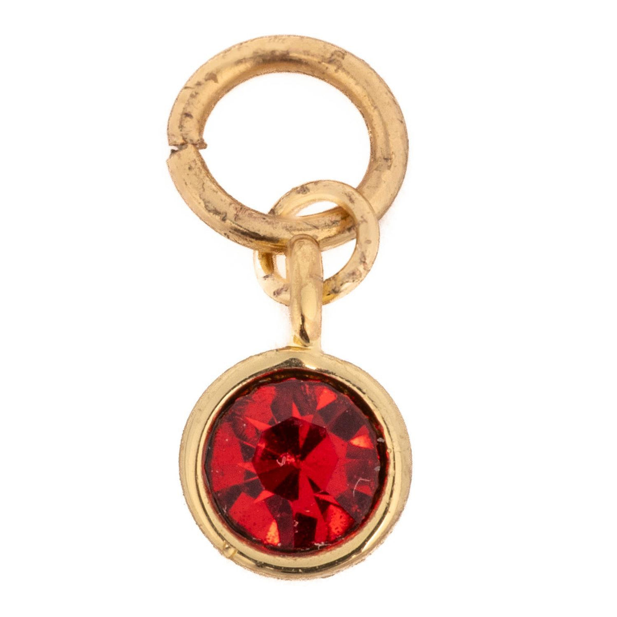 Thea Charm Birthstone featuring a round red crystal in a gold-toned bezel setting with jump rings.