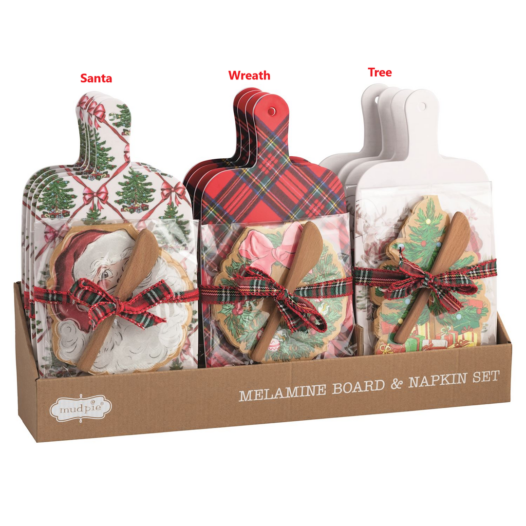 Three styles of Christmas melamine board sets with napkins and wooden spreaders in a display box.