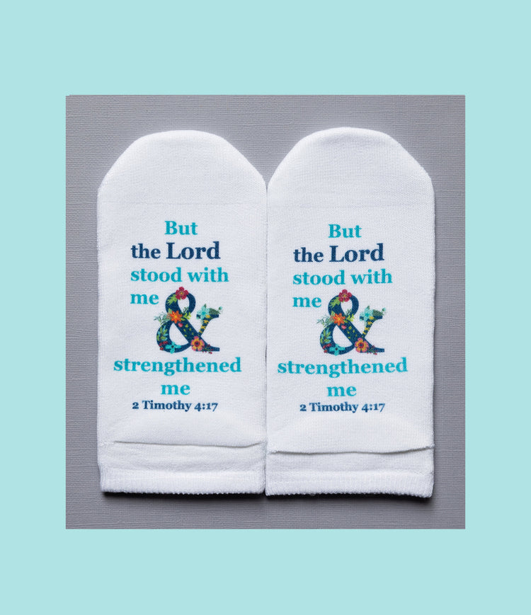 White no-show socks featuring the Bible verse 2 Timothy 4:17 with a floral ampersand design.