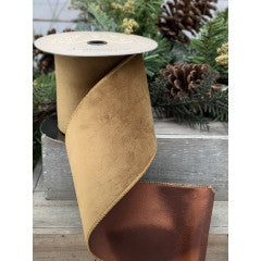 2.5 inch wide gold velvet ribbon with a metallic copper taffeta backing on a spool.