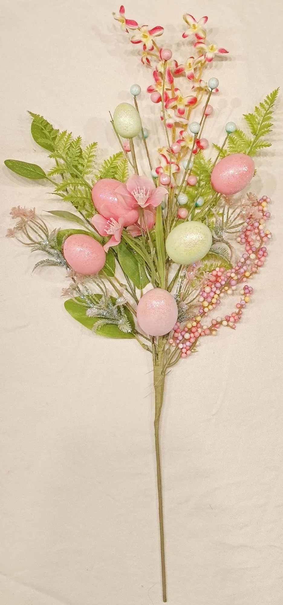 Pink egg-shaped spray bottle with green accents.
