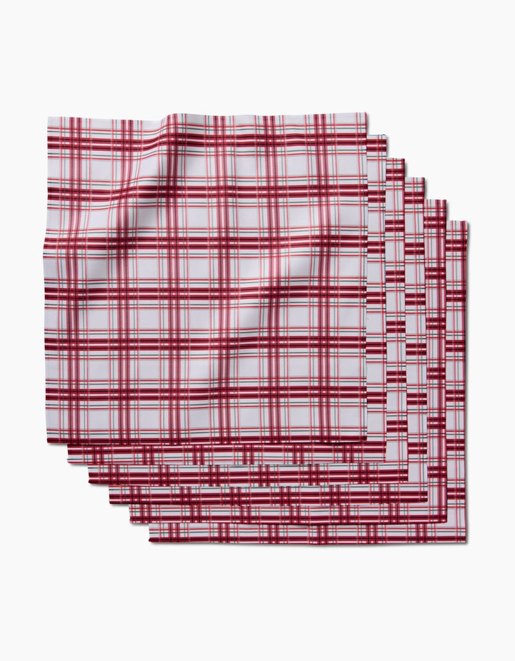 Set of six square geosuede dinner napkins with a single-sided geometric print in neutral tones.