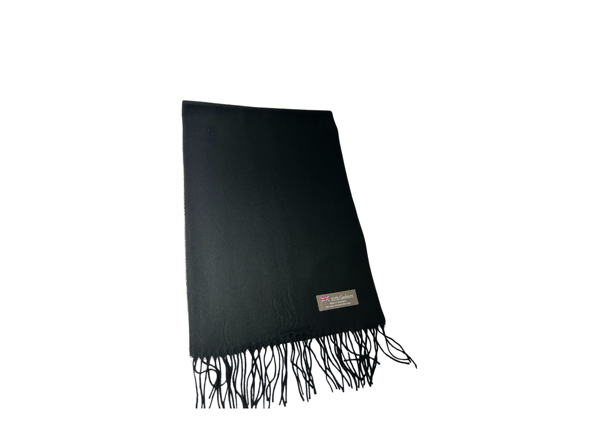 Black 100% cashmere scarf with fringe edges and a "Made in Scotland" label.