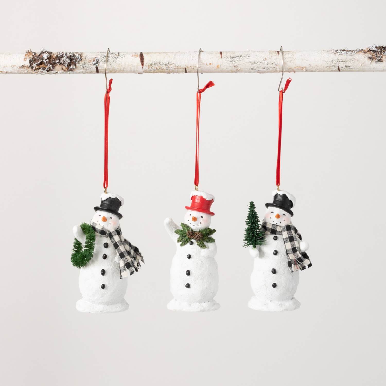 Polyresin snowman ornament with multicolor festive attire hanging from a hook.