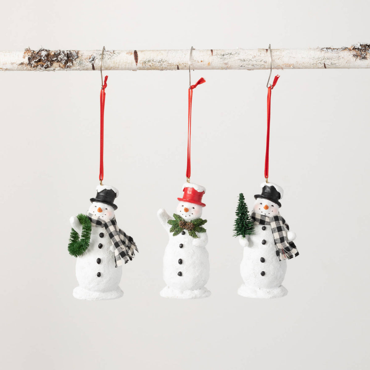 Polyresin snowman ornament with multicolor festive attire hanging from a hook.