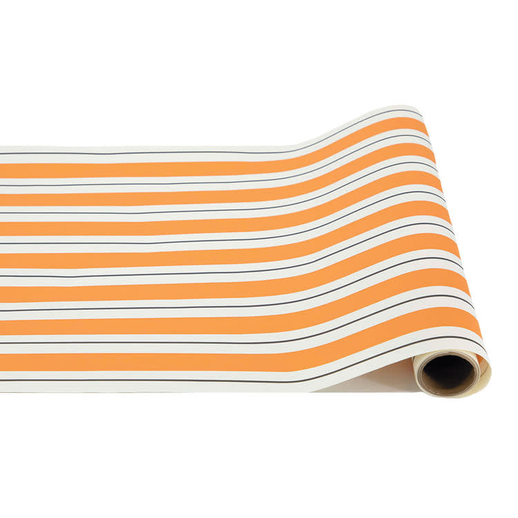 Orange paper table runner with black stripes measuring 20 inches wide by 25 feet long.