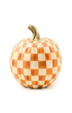 Small orange pumpkin with a checkered black-and-white pattern