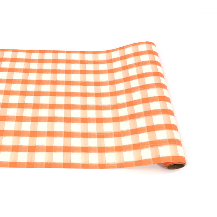 Orange painted check paper table runner with a grid pattern.