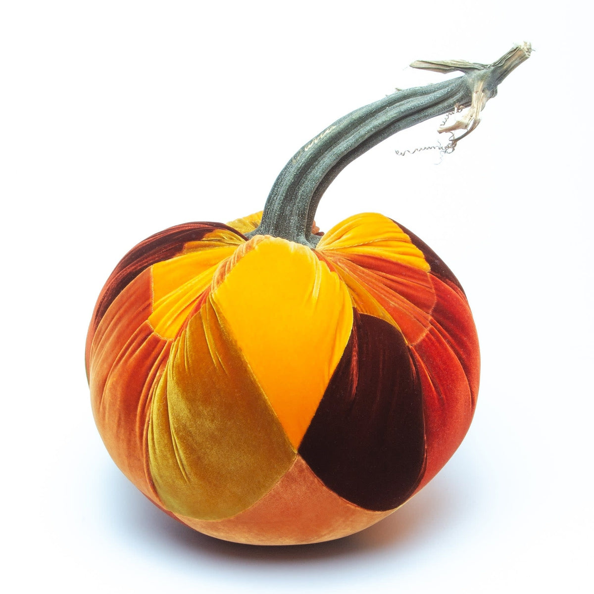 Handmade patchwork velvet pumpkin in orange with a natural stem.