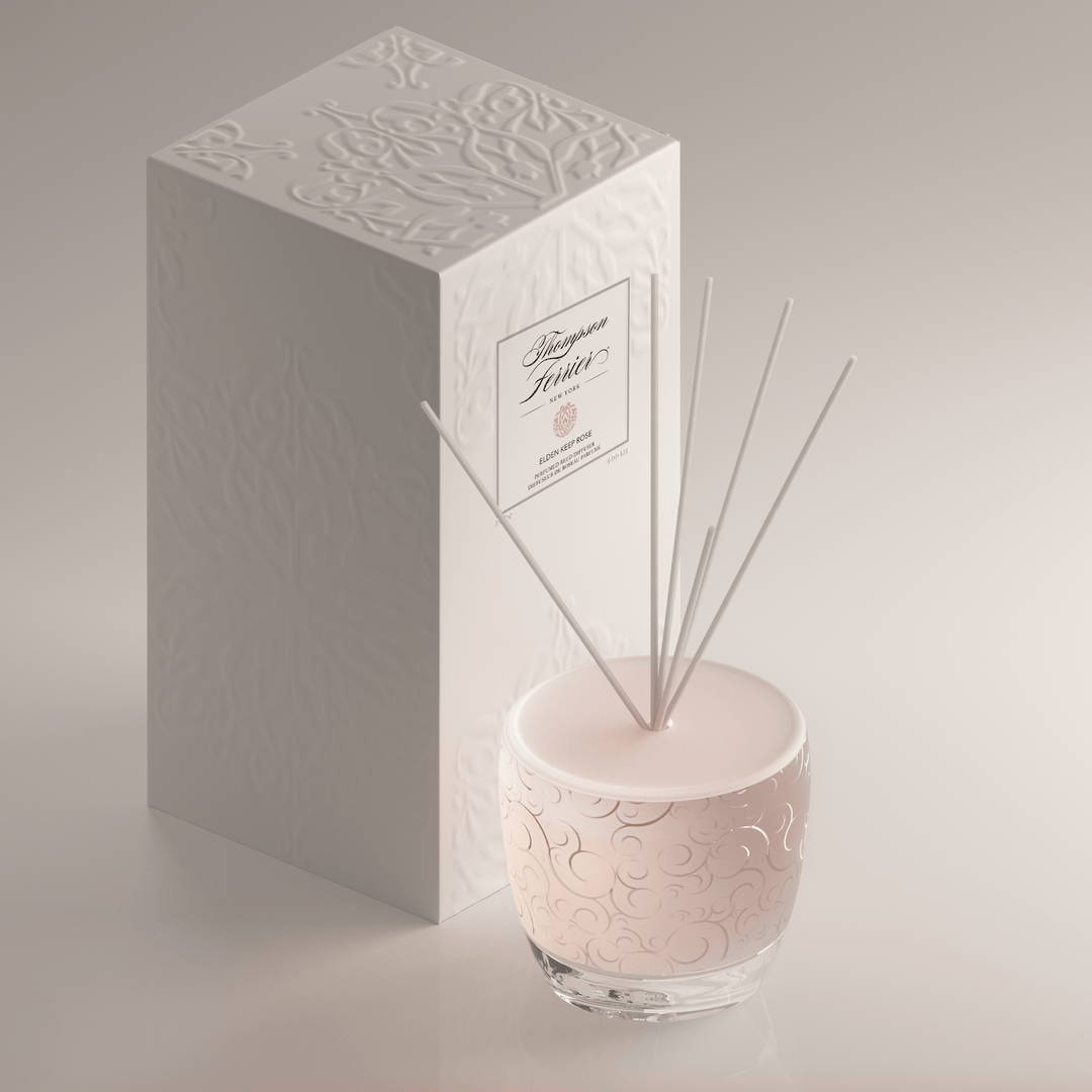 Elden Keep Rose Reed Diffuser with a clear glass bottle containing pink rose-scented liquid and bamboo reeds.