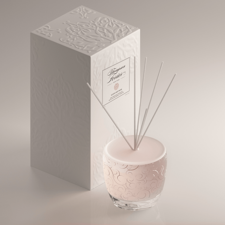 Elden Keep Rose Reed Diffuser with a clear glass bottle containing pink rose-scented liquid and bamboo reeds.