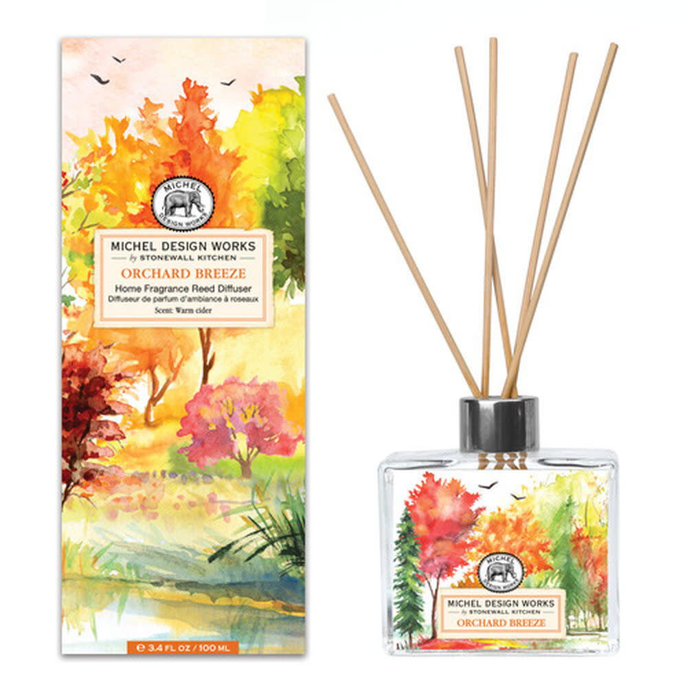Orchard Breeze home fragrance reed diffuser with clear glass bottle containing light amber liquid and natural wood reeds.