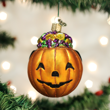 Trick Or Treat pumpkin ornament with orange body, black stem, carved face pattern, and hanging loop.