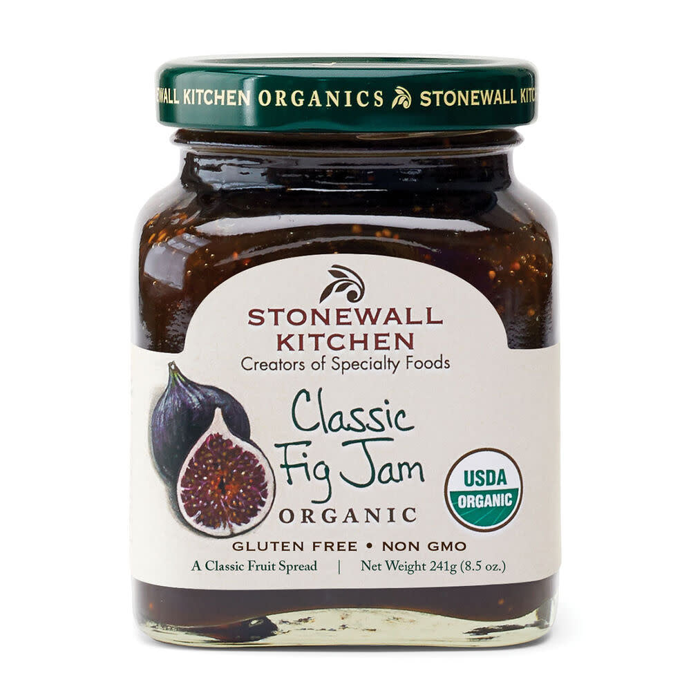 Jar of organic fig jam with a honey-colored spreadable texture.