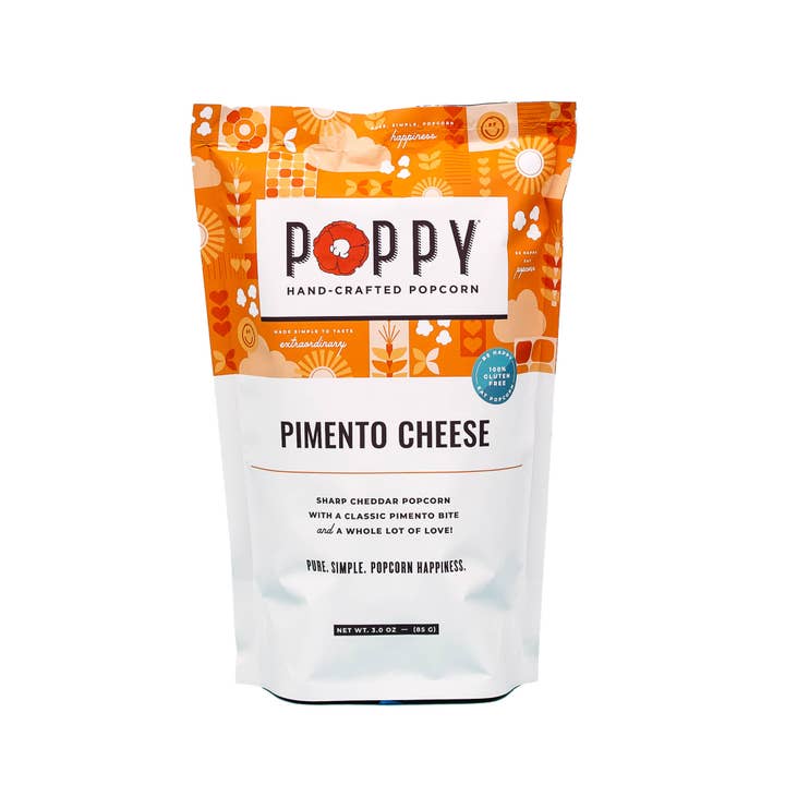 Open bag of white cheddar popcorn with dill flakes visible inside.
