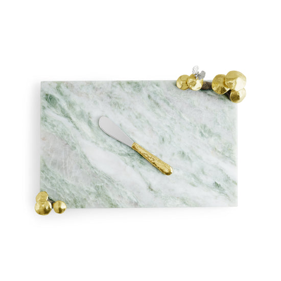 Green marble cheeseboard with gold mushroom accents and a matching spreader.