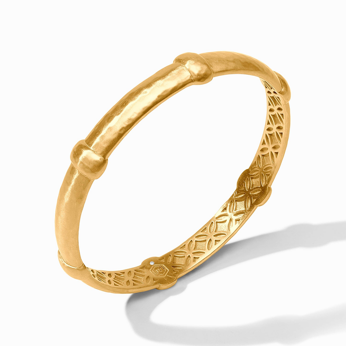 Sahara Bangle in 24K gold plate with a hammered texture and decorative interior lattice pattern.