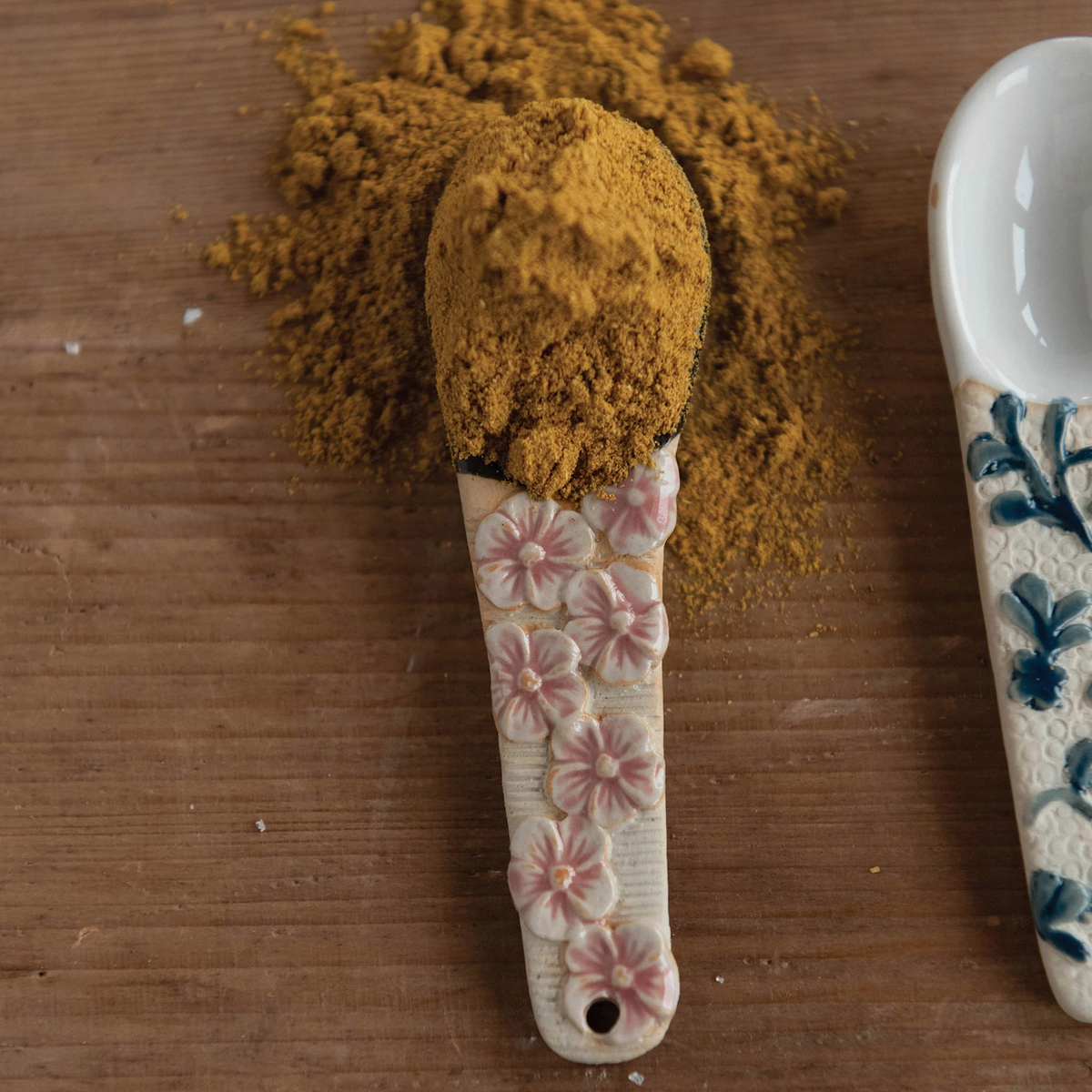 Stoneware spoon with floral-patterned handle in earthy tones