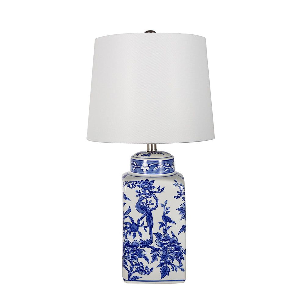 Blue ceramic vase lamp with white linen shade featuring a cylindrical silhouette.