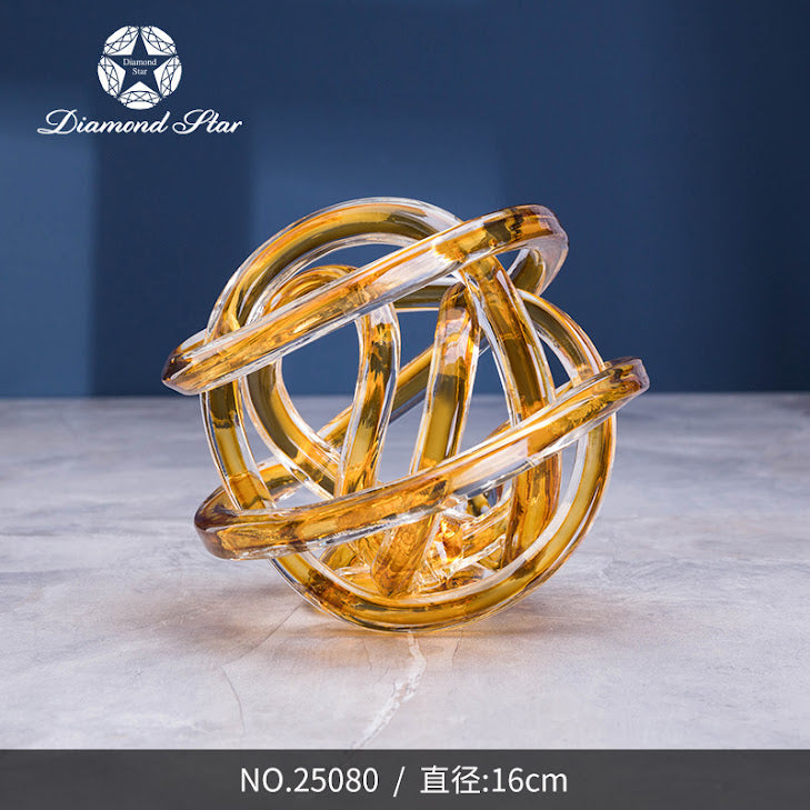 7-inch glass knot sculpture with a clear finish in a cubic shape.