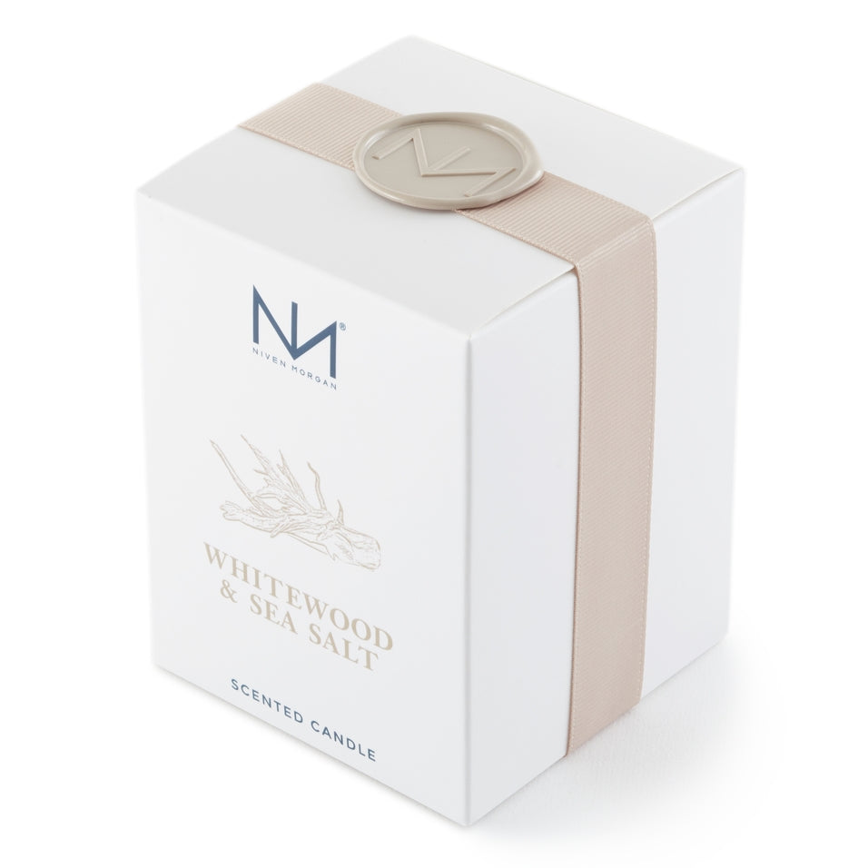 Dark navy glass soy blend candle with white wood grain label