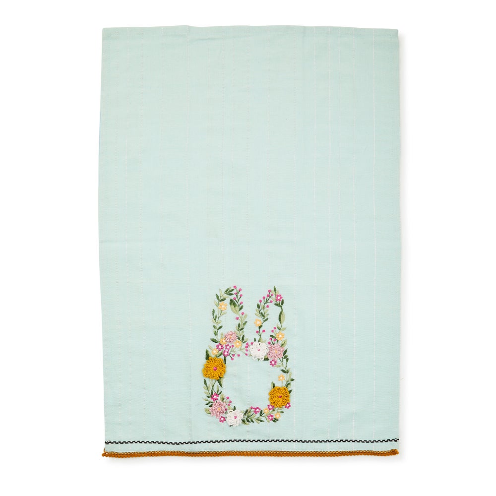 Light blue cotton dish towel featuring a bunny silhouette made of embroidered colorful flowers.