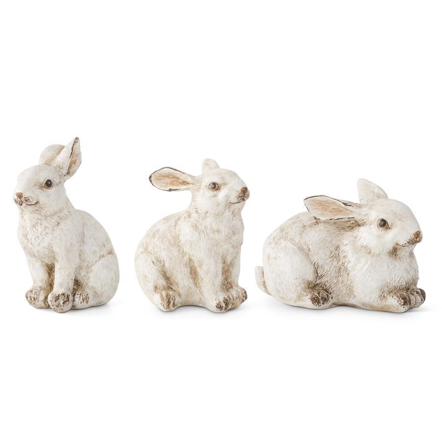 Three small gray polyresin bunny figurines with a smooth finish.