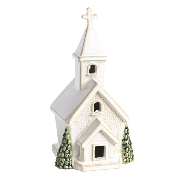 White ceramic church sitter with pressed lace texture, green trees, and a cross on the steeple.