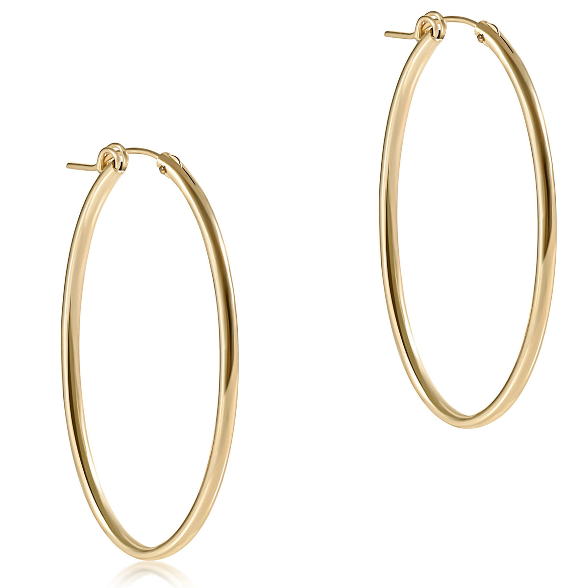Sleek smooth oval gold hoop earring measuring two inches in diameter