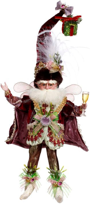 Gold Christmas party fairy figurine with glittery wings standing on a decorative base.