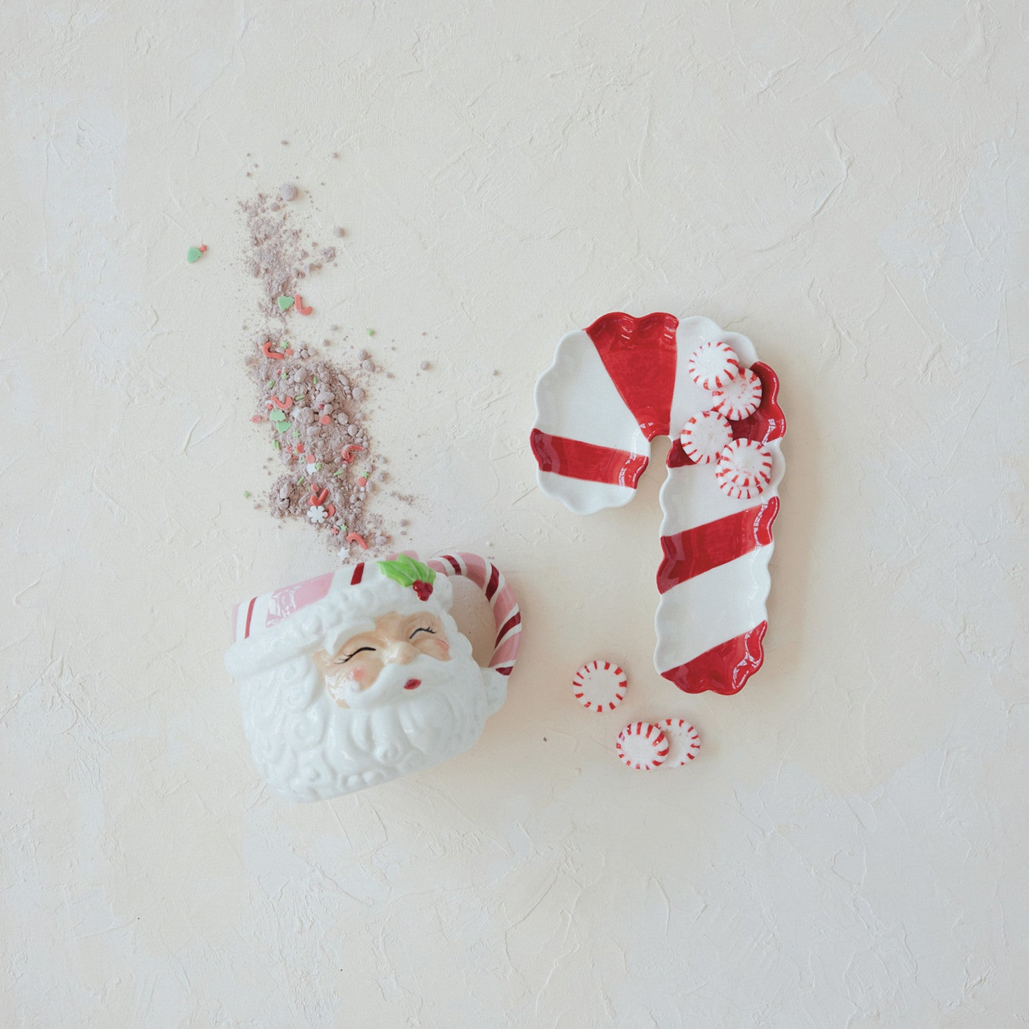 Stoneware scalloped candy cane shaped dish in red and white stripes with peppermint candies.