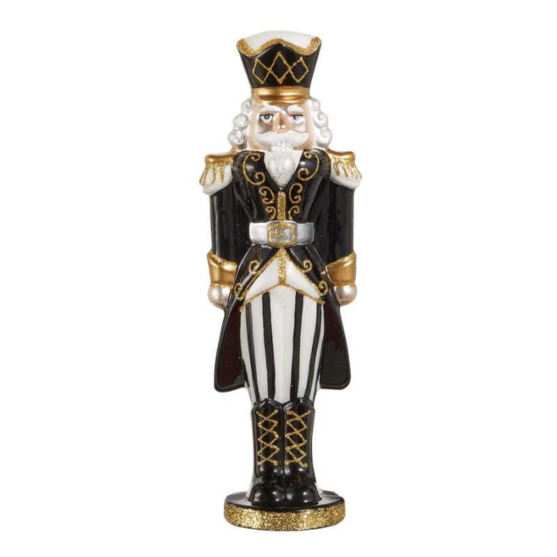 10.5-inch glass nutcracker in black and white with gold glitter accents and striped pants.