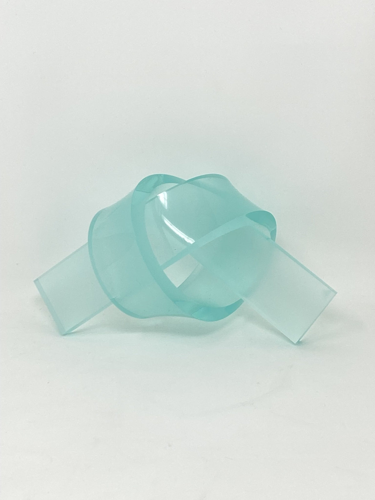 Acrylic knot pendant in clear acrylic with a polished finish.